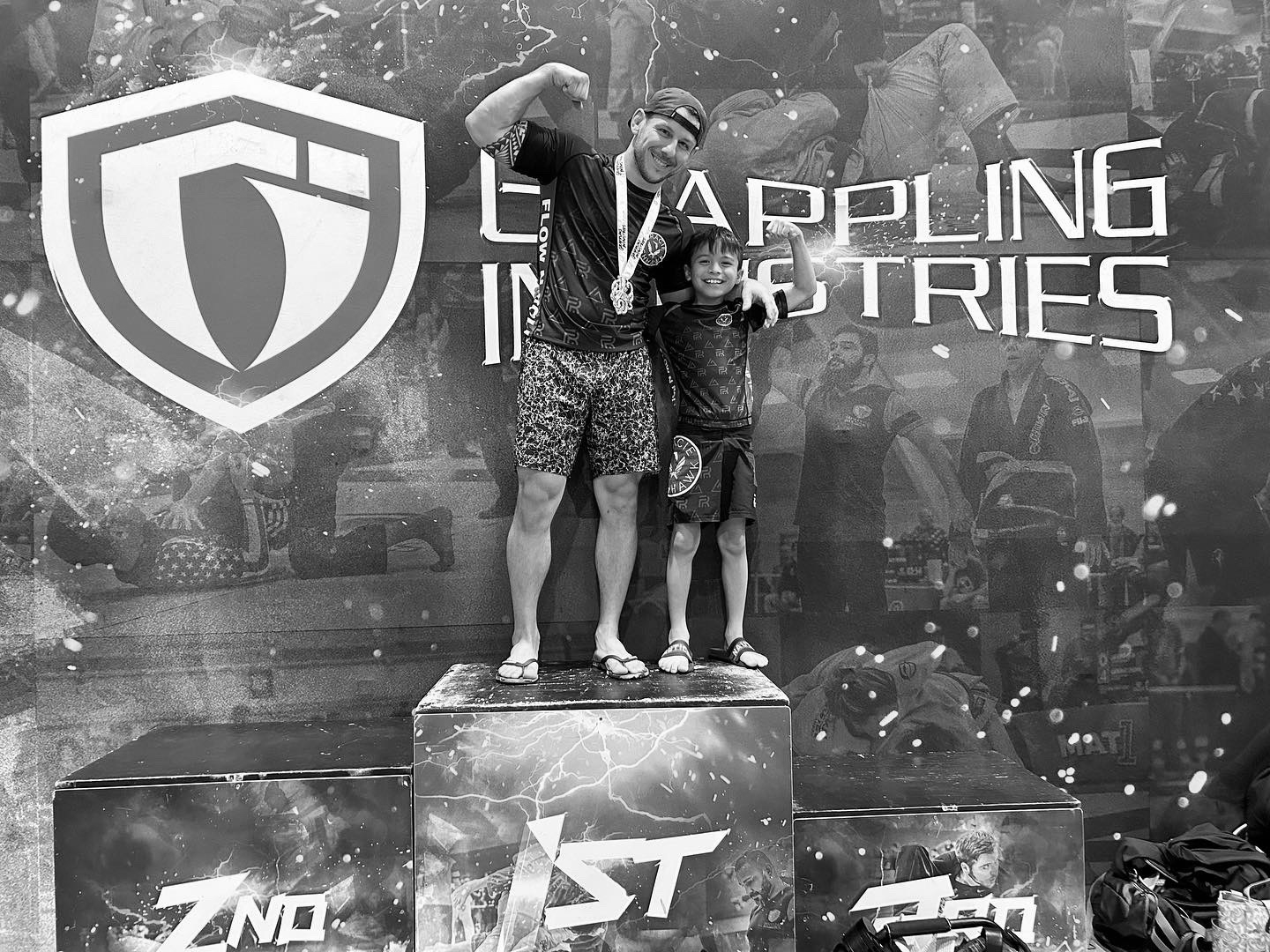 A Studio 42 coach and his son on the competition podium — family on the mats